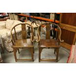 Pair of Chinese Hardwood Horseshoe Shaped Chairs, the splat with Carved Circular Chinese Emblem