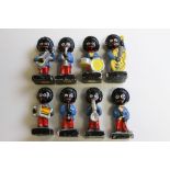 Eight vintage hand painted Golly band figures with paper labels to base (8)