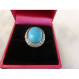 An 18ct white gold turquoise and diamond cluster ring