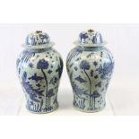 Large pair of Oriental ceramic blue & white Urns depicting Fish, with Brass Rings fitted to the