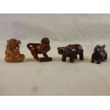 Four miniature wooden netsukes to include foo dog, money cow, rabbit (signed) and dragon (signed)