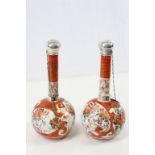 A pair of Japanese silver capped vases, bulbous form with long narrow necks with silver collar and