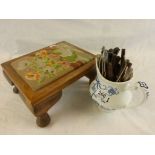 A tapestried wooden foot stool together with a Meakin blue and white jug containing assorted