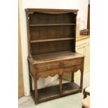 Small 18th century Style Oak Dresser, the shelved back above Two Drawers, Shaped Apron and Pot Shelf