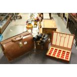 A vintage leather briefcase ,a pair of cased binoculars etc.