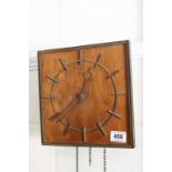 An art Deco style wooden wall clock.