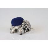 A silver elephant pincushion