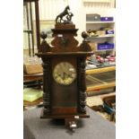 An antique mahogany cased wall clock with two train movement in the vienna style.