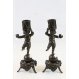 Pair of vintage Bronze Candlesticks modelled as Cherubs balanced on Balls, with Drums to their heads