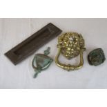 Brass lion mask door knocker, a face door knocker, an urn door knocker and a letter box