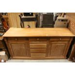 Pine Dresser Base with Three Drawers above a bank of Three Drawers flanked either side by Cupboards,