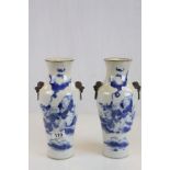 Pair of Chinese blue & white vases with figurative design and Lion masque simulated handles, both