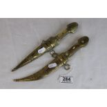 A Middle Eastern Jambiya dagger with bone handle and brass scabbard together with a similar Middle