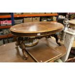 Victorian Burr Walnut Oval Coffee Table raised on four carved splayed legs with ceramic castors