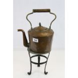 Antique Copper Kettle with Brass and Wooden Handle stood on a Brass & Iron Trivet