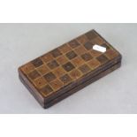 Early 20th century travel chess set, gilt leather board with dyed bone counters, dimensions when