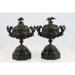 Pair of vintage decorative Bronze Urns with Cherub handles and Bird finials to the lids, on black