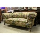 19th century Scroll Arm Chesterfield Style Sofa, upholstered in floral fabric of muted tones, raised