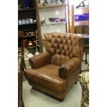 Large Tan Brown Leather Wing Back Armchair, with button back and brass studding