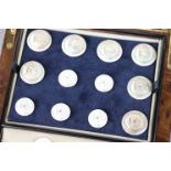 Cased set of Firmin & Sons buttons depicting a star and flag, comprising two sizes of button and a