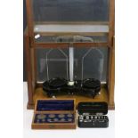 Early 20th century Wooden Cased Set of Balance Scales together with a Cased Set of Eleven Weights