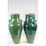 Pair of Persian Green Glazed Wine Vessels, each with four handles, approx. 75cms high