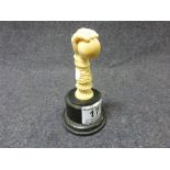 19th century carved ivory seal handle depicting a hand clutching a ball, height approximately 7cm,