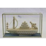 Glass cased Bone carving of an Oriental boat