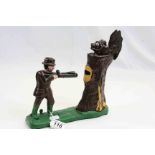 Painted Cast Iron Money box with Hunter shooting at a Tree