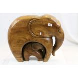 Large carved wooden elephant ornament with baby elephant below, height approximately 47cm