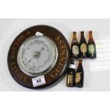 Wooden cased circular wall Barometer marked "Lovely Day for a Guinness" with five miniature