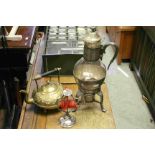 A reproduction silver plated wax jack , a wine jug and a copper teapot.