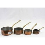 Set of Four Graduating Copper Saucepans with Brass Handles