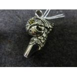 Silver whistle in the form of a parrot head with glass eyes