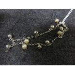 Silver bracelet set with pearls and silver balls