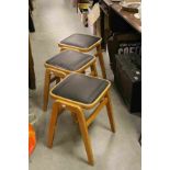 Set of Three Retro Beech Wood Stacking Stools with Black Vinyl Seats