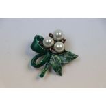 Silver brooch with green enameled leaves set with pearl