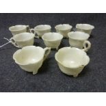 Set of nine early 20th century Oriental soapstone small tea cups, with handles, stylised oriental