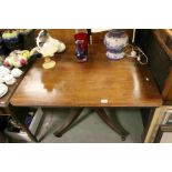 Early 19th century Mahogany Rectangular Tilt Top Table raised on a central pedestal with four reeded