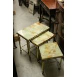 Onyx and Gilt Metal Nest of Three Tables, all on castors