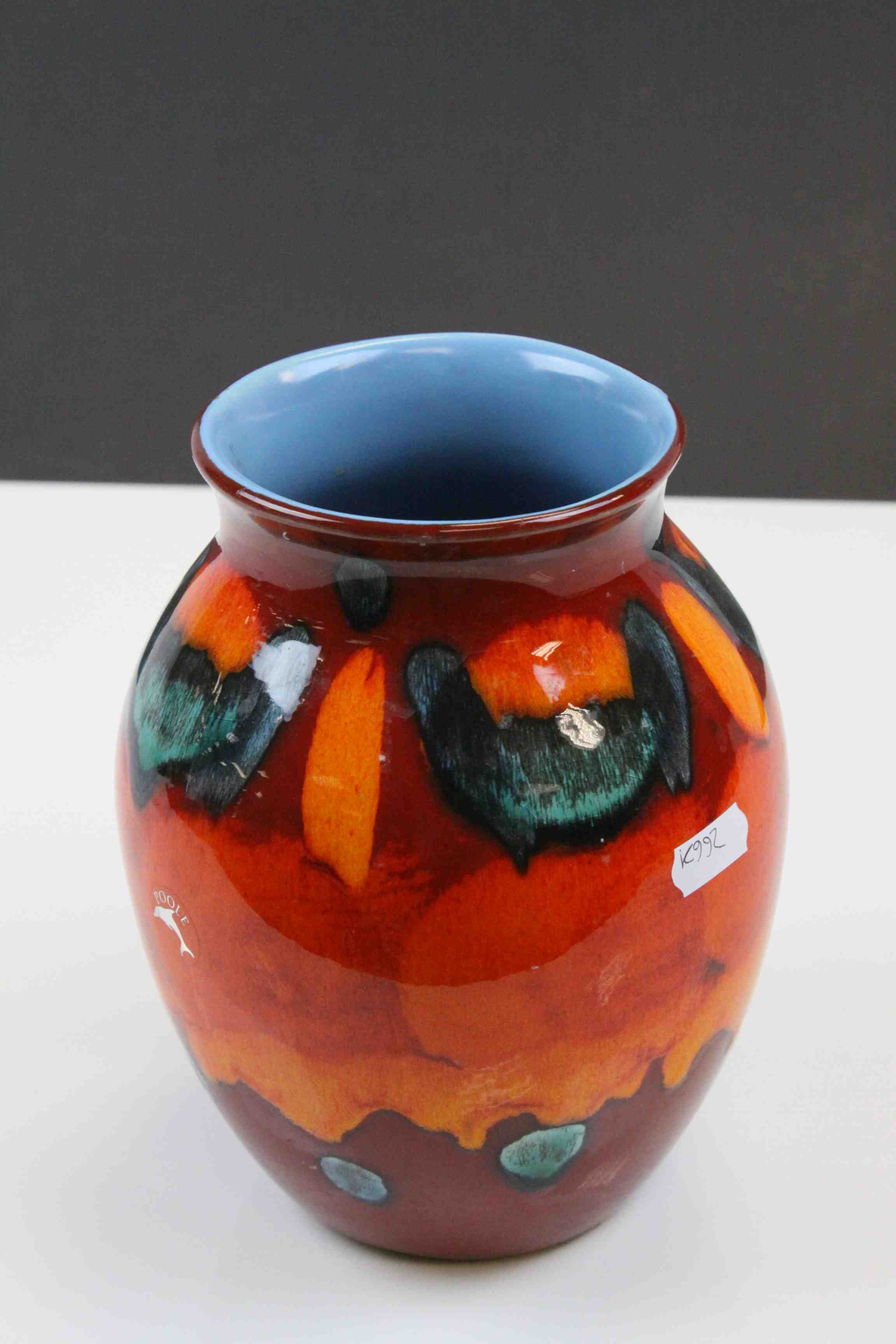 Poole Pottery vase in bright Orange & Red colours and pale Blue interior