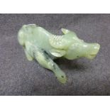 Soapstone carved figurine of a recumbent Asian cow, head raised, height approximately 9cm, length