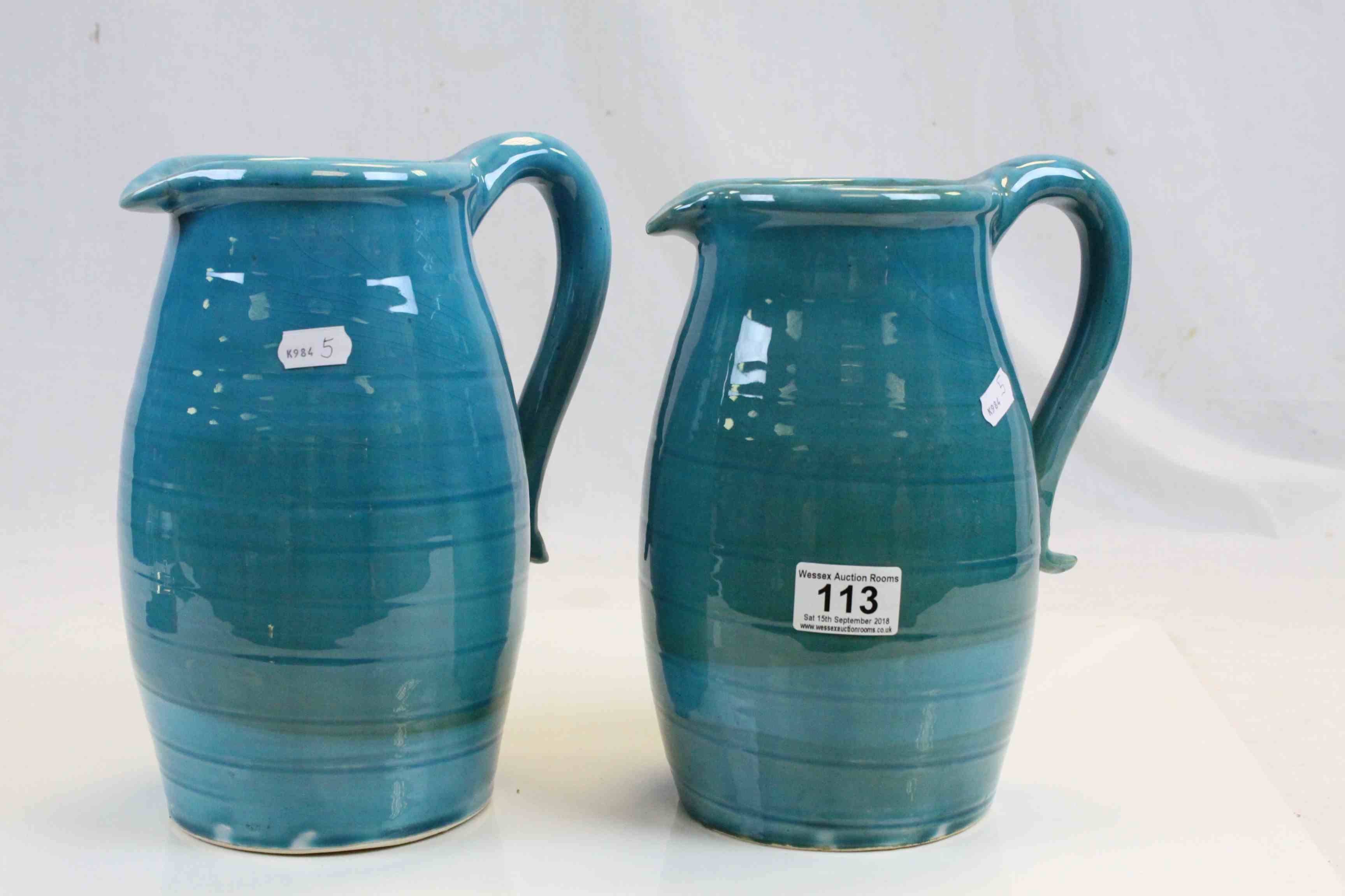 Two Persian Cyan Glazed Pitchers / Water Jugs, approx. 25cms high