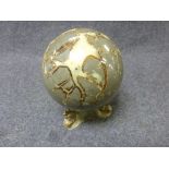 Large hardstone sphere raised on brass stand, supported by the tails of three fish, total height