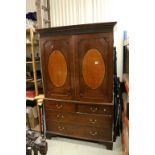 19th century Mahogany Linen Press, the two doors with central oval inlaid panels opening to reveal