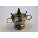 George V silver table lighter of circular pedestal form with twin handles, engine turned