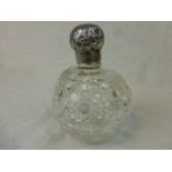 Large Victorian silver topped cut glass scent bottle of ovoid form, embossed floral and foliate