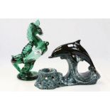 An unmarked Poole Pottery table ligth holder in the form of a dolphin plus a green glass horse (2)