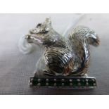 Silver Squirrel Brooch with Ruby Eyes standing on an Emerald Set Branch