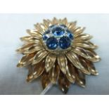 Large vintage gilt brooch in the form of a flower, three rows of petals, the centre set with blue